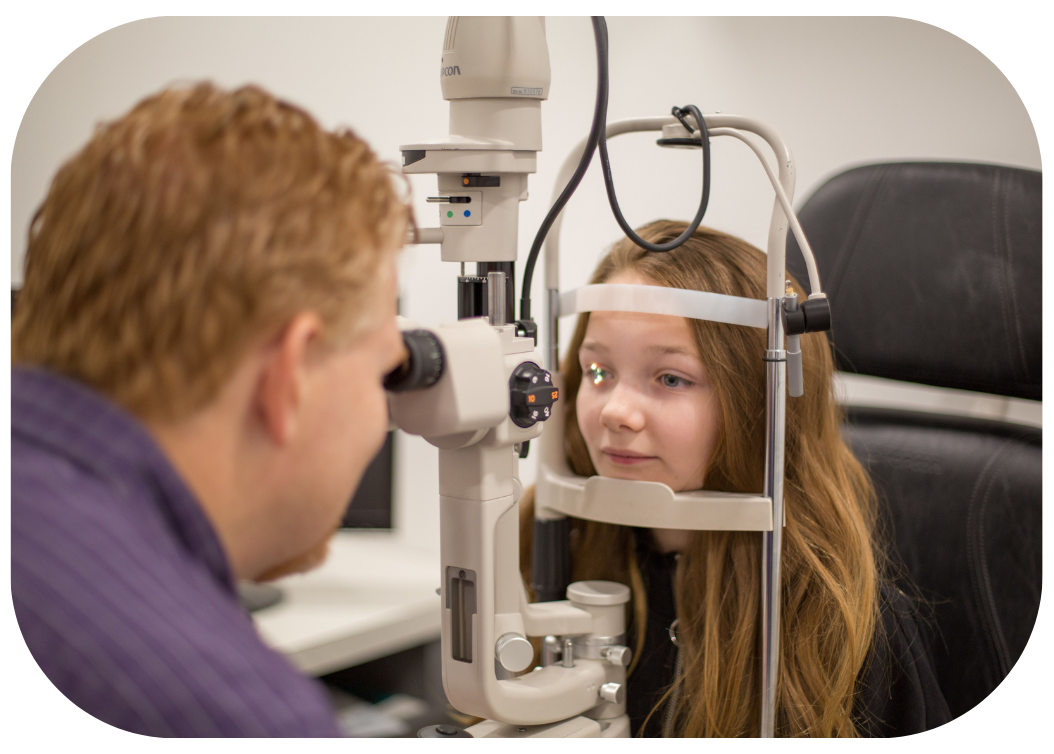 Dr. Holtom doing an eye exam on a young girl.